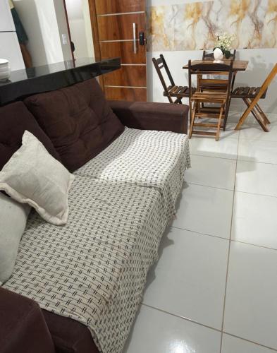 a couch sitting in a living room with a table at Grace Palace in Paraipaba