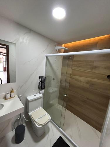 a bathroom with a shower and a toilet and a sink at Casa da Dinda102 in Rio das Ostras