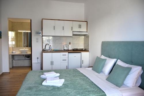a bedroom with a bed with towels on it at Soultana’s house in Mourteri
