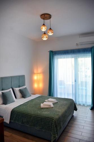 a bedroom with a bed with two towels on it at Soultana’s house in Mourteri