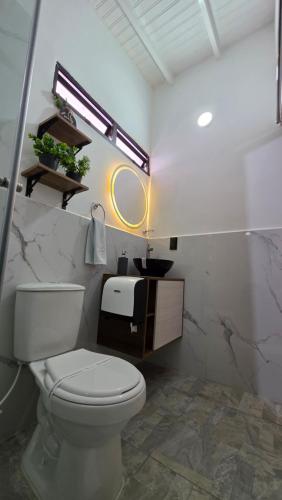a bathroom with a white toilet and a sink at Naiot Hotel Boutique in Medellín