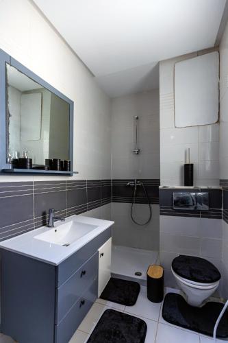 a bathroom with a sink and a toilet and a mirror at VIP Home in El Aouina Station