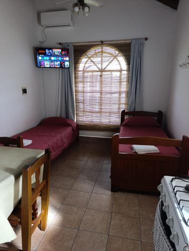 a room with two beds and a window at Hotel de Campo con Piscina y Cabañas- Ideal Relax en Concordia in Concordia