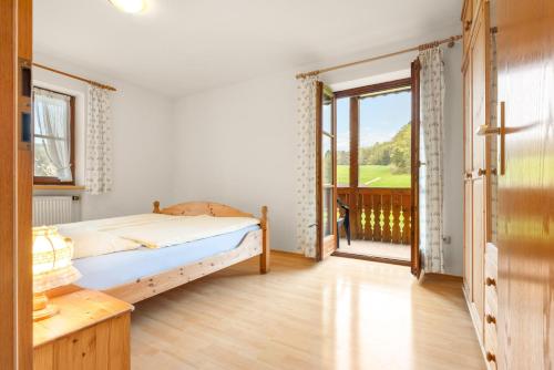 a bedroom with a bed and a large window at Mayerbauer in Piding