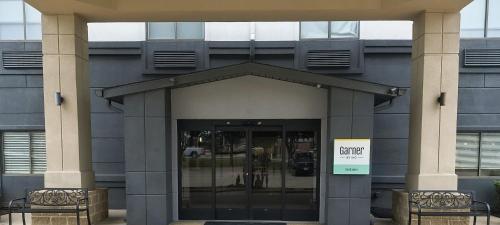 an entrance to a building with a sign on it at Grander Inn & Suites by IHG in Tyler
