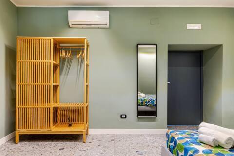 a room with a bedroom with a bed and mirrors at Walk to Fly Gate 65 Appartaments in Naples