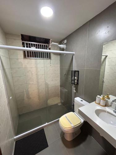 a bathroom with a shower and a toilet and a sink at Casa da Dinda 104 in Rio das Ostras