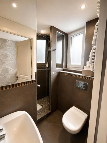 a bathroom with a toilet and a sink at Hotel des Bains in Paris