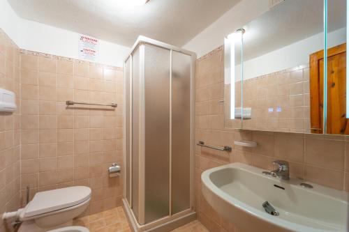 a bathroom with a toilet and a sink and a shower at Mury by DomusAway in Porto Istana