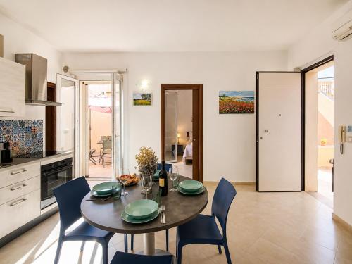 a kitchen and dining room with a table and chairs at Corte Dei Fiori Acquaviva Apartments in Marittima