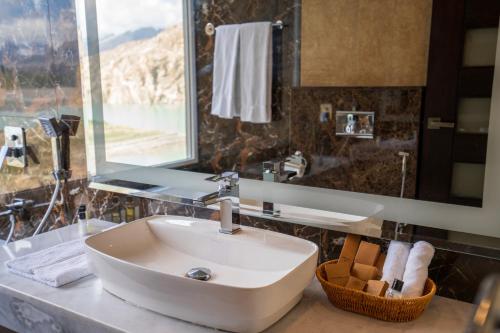 a bathroom with a sink and a mirror at Pearl Continental Attabad Lake, Hunza in Hunza Valley