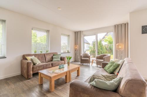 a living room with two couches and a coffee table at Hoogelandt 106F in De Koog