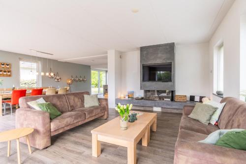 a living room with two couches and a table at Hoogelandt 106F in De Koog