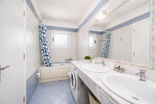 a bathroom with two sinks and a tub at Villa Aphrodite in Plaka