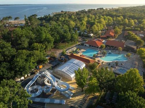 an aerial view of a resort with a swimming pool at La Cabane du Lac - Biscarrosse 5 étoiles in Biscarrosse