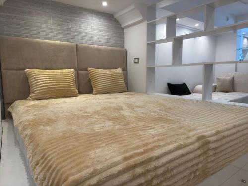 a bedroom with a large bed with gold pillows at Sidi studio 8bis in Sidi Bou Saïd