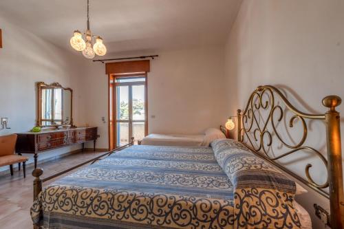 a bedroom with a bed and a dresser and a window at Casa Lucia a Torre Lapillo in Torre Lapillo