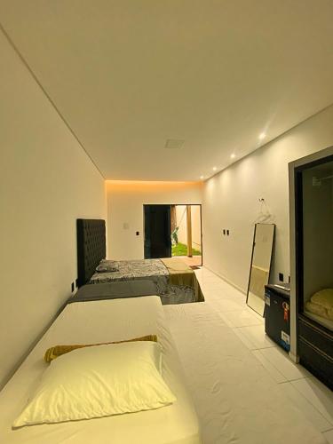 a bedroom with two beds and a flat screen tv at Good Winds Kite House in Cruz
