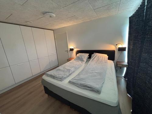 a bedroom with a bed with two pillows on it at New apartment, only 4 km from the highway in Horsens