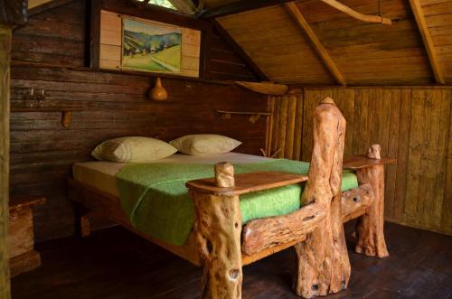 a bedroom with a bed in a log cabin at My Olive Garden Camp in Bar