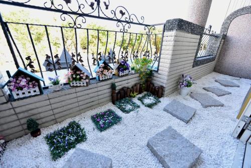 a miniature garden with plants and a fence at Happiness Childhood in Hualien City