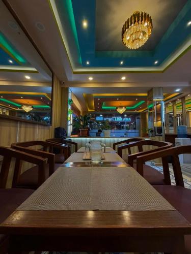 a dining room with a long table in a restaurant at CG Hotel in Kathmandu