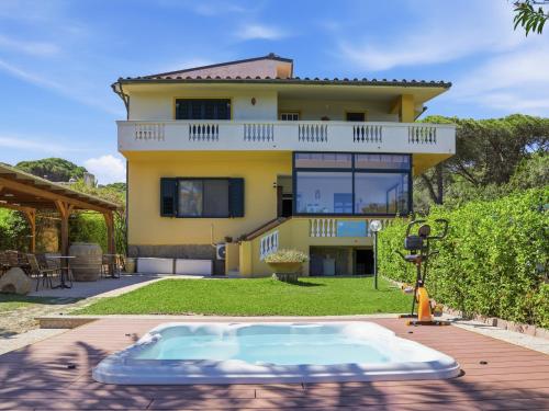 a house with a swimming pool in front of a house at B&b Giglio di Mare in Cala Liberotto