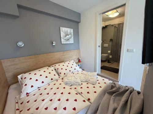 a bedroom with a bed with red hearts on it at Studio Claudia in Opatija