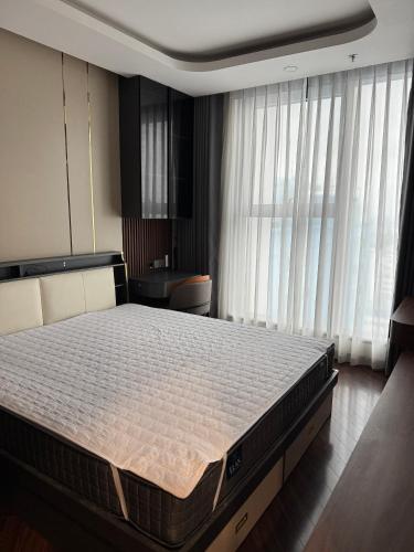 a bedroom with a large bed in front of a window at 7Homestays in Ðông Khê