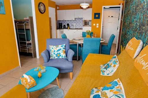 a living room with two couches and a table at La villa Margats - Charme & détente en bord de mer in Bray-Dunes