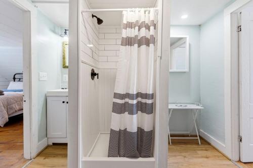 a bathroom with a shower curtain in a room at Charming Kennebunk Cape - Walk to Dock Square! in Kennebunk