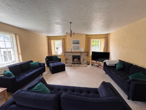 a living room with two couches and a fireplace at Mordor Lodge in Braunton