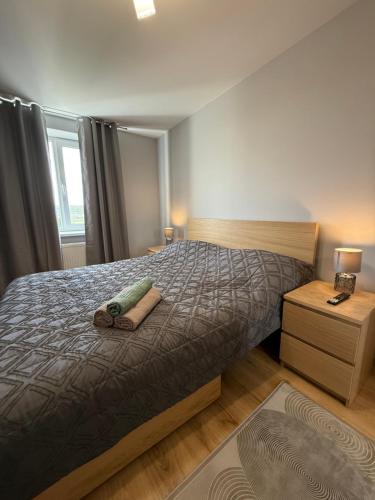a bedroom with a bed with two towels on it at Kogălniceanu 23 in Căuşeni