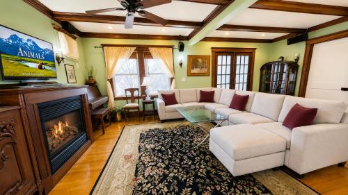 a living room with a couch and a fireplace at Victorian Condo in Boston