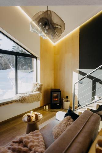 a living room with a couch and a fireplace at Monside Resort - FIRE CABIN in Borzont