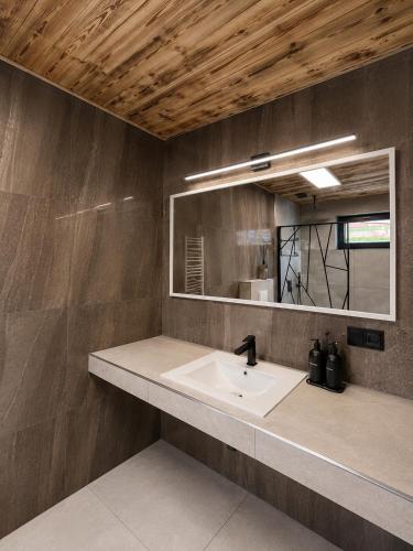 a bathroom with a sink and a mirror at Przystań Ukoya in Koniaków