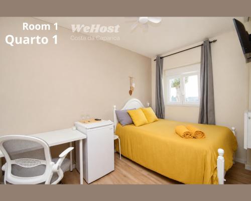 a bedroom with a yellow bed and a desk at We Host Costa da Caparica in Costa da Caparica