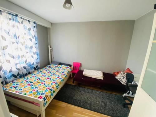 a bedroom with two beds and a window at Adam1 in Uppsala