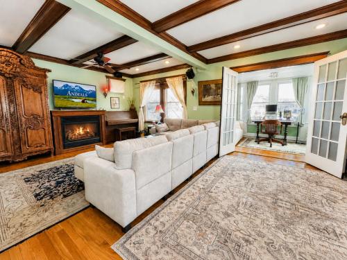 a living room with a couch and a fireplace at Victorian Condo in Boston