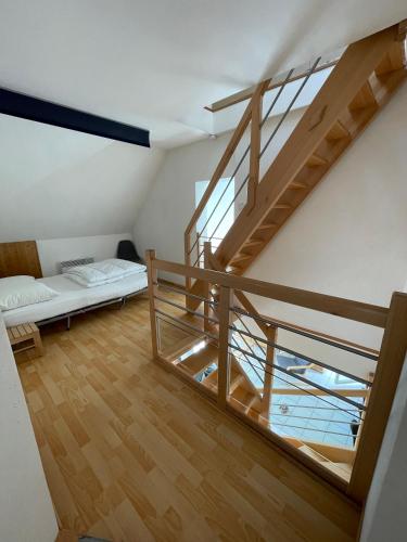 a room with a staircase and a bed in it at Maisons avec terrasse et parking in Colmar