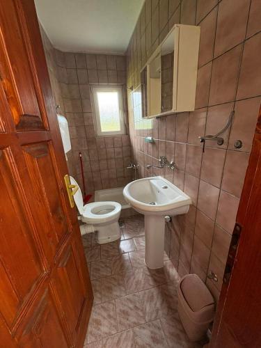 a bathroom with a toilet and a bidet and a sink at Canovic vacation in Plav