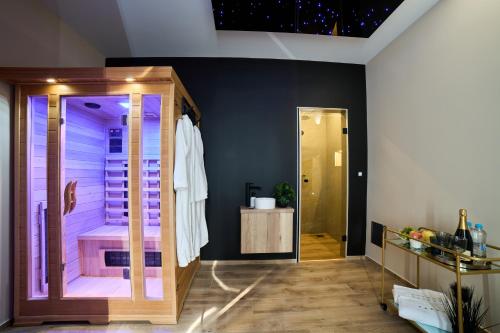a bathroom with a walk in shower with purple lighting at Apartmaji na Pošti in Podsreda