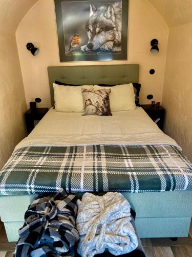 a bedroom with a bed with a wolf picture on the wall at Rabbit Hole Hotel in Laiksaare