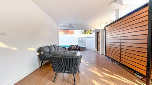 a living room with a couch and chairs at Pattaya Tropical Pool Villa in Pattaya