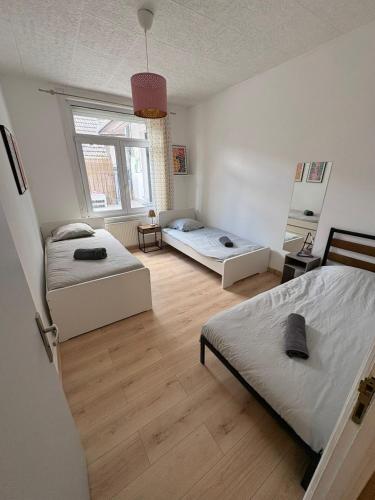 a bedroom with two beds and a window at Appart 10 pers - Lille Lambersart - Parking & Terrasses in Lambersart