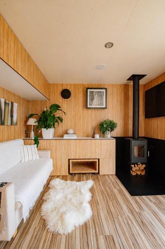 a bedroom with a bed and a wood paneled wall at Nedomek by Homester in Neslovice