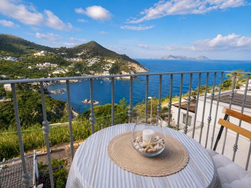 a table on a balcony with a view of the ocean at Maridea - Appartamento al Tramonto in Ponza