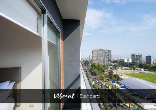 a view of the city from the balcony of a building at G15 Apartments by Vibrant in Lima