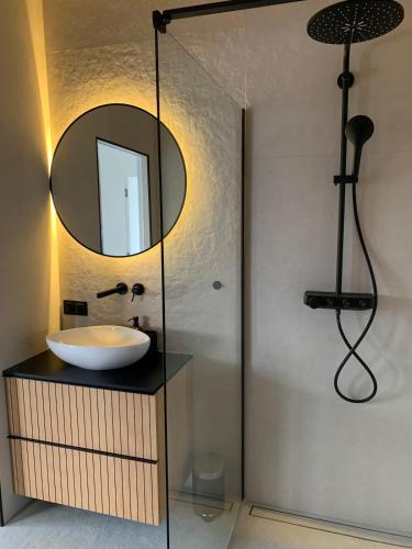 a bathroom with a sink and a mirror at SolMarina Apartment for Rent in Wiślinka