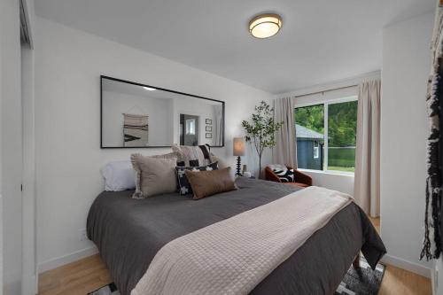 a bedroom with a large bed with a large mirror at Seal Cove in Lilliwaup